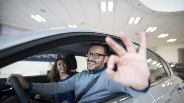 happy-customer-buying-new-car-dealership